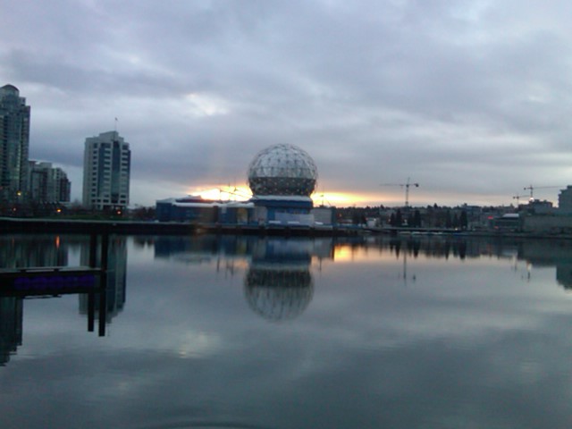 Sun coming up over Science world in False creek